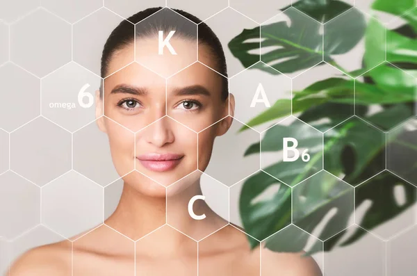 Woman next to green plant with vitamin icons and symbols — Stock Fotó