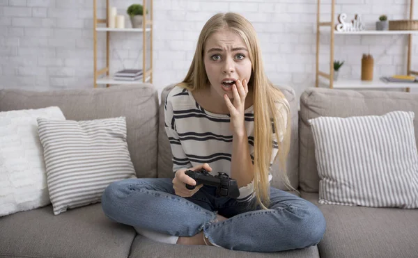 Shocked girl with joystick got stuck during video game — Stok fotoğraf