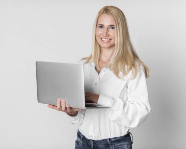 Confident Mature Businesswoman Smiling At Camera At Studio