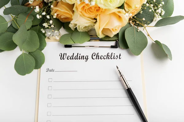 Lege checklist voor bruiloften met creatieve pen en rozen op wit — Stockfoto