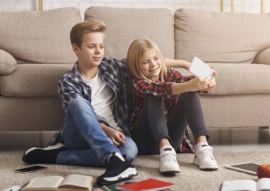 Brother And Sister Posing Making Selfie Sitting On Floor Indoor