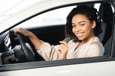 Joyful Woman Showing Key Sitting In Drivers Seat In Automobile