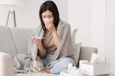 Girl suffering from temperature and runny nose