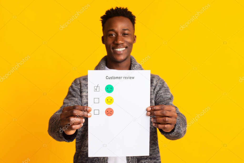 Young african man holding customer review with excellent feedback