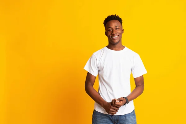 Charming young african man in casual wear widely smiling — Stok fotoğraf