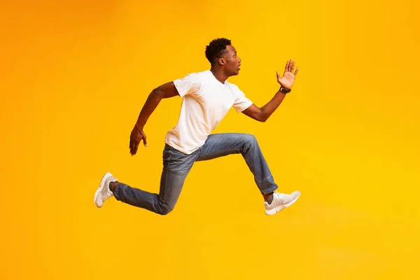Chico africano saltar, correr rápido, darse prisa a las ventas o descuentos —  Fotos de Stock