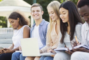 Cheerful international students preparing for final exams