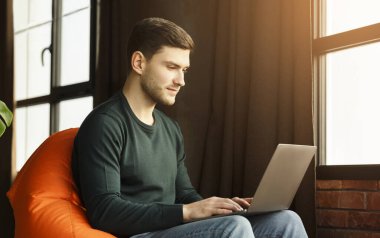 Freelancer Man Using Laptop Sitting In Workspace Indoor