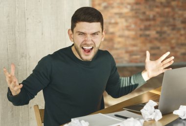 Man Shouting And Gesturing Having Nervous Breakdown In Office