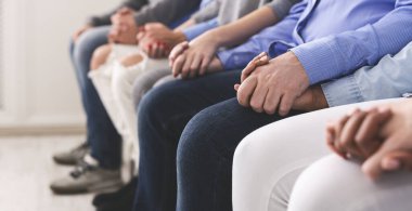 Rehabilitasyonda terapi grubu toplantısında el ele tutuşan bağımlılar