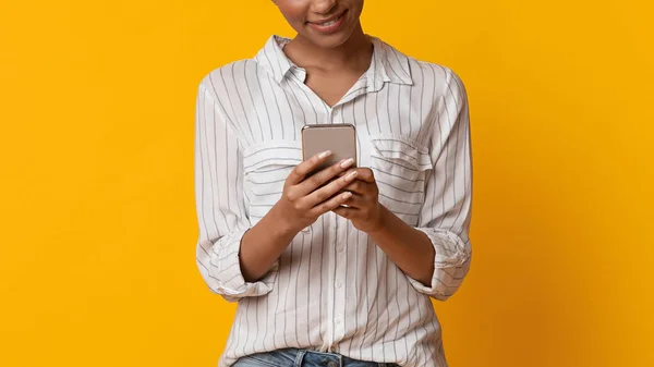 Σύγχρονη Smartphone στα χέρια του αγνώριστο κορίτσι της Αφρικής, κίτρινο φόντο — Φωτογραφία Αρχείου