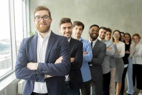 Happy business team headed with boss standing in row — Stock Photo, Image