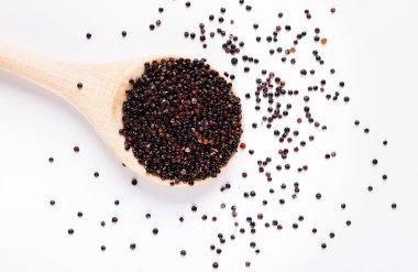Healthy diet concept. Black quinoa in round wooden spoon