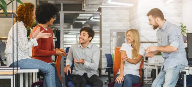 Affectionate young team having little break during working process