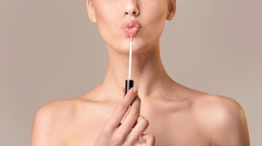 Unrecognizable Woman Applying Lipstick Posing Over Beige Background, Panorama