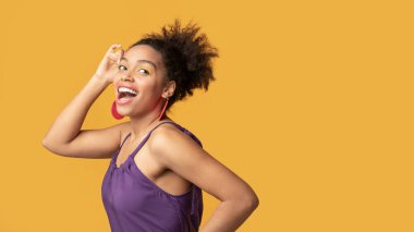 Happy black woman looking away at studio