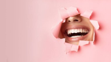 Unrecognizable Woman Smiling Through Hole In Pink Paper, Panorama