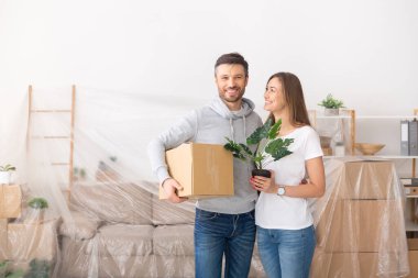 Moving and repair. Loving couple enjoying new apartment