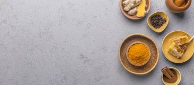 Curcuma longa spice with, ginger and honey on gray