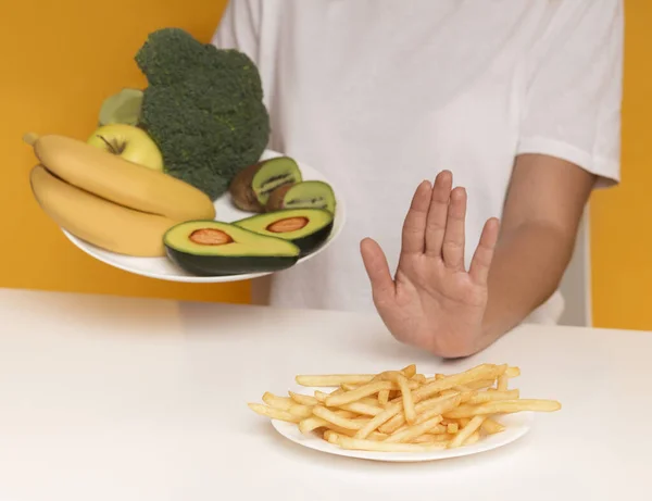 Woman refusing to eat french fries and choosing healthy food instead — 스톡 사진