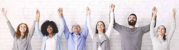 Group of happy diverce people holding hands, raising arms up, panorama — Stock Photo, Image