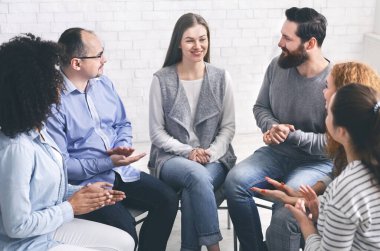 Community Members Applauding To Mentor At Therapy Session In Rehab