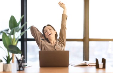 Happy european manager stretching body at work