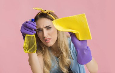 Housewife washing tiny dirt spot on camera