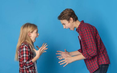 Angry Little Brother And Sister Emotionally Screaming At Each Other
