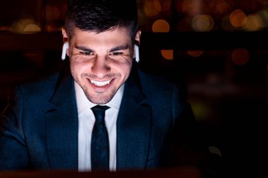 Cheerful Man In Earbuds Making Video Call Sitting In Office