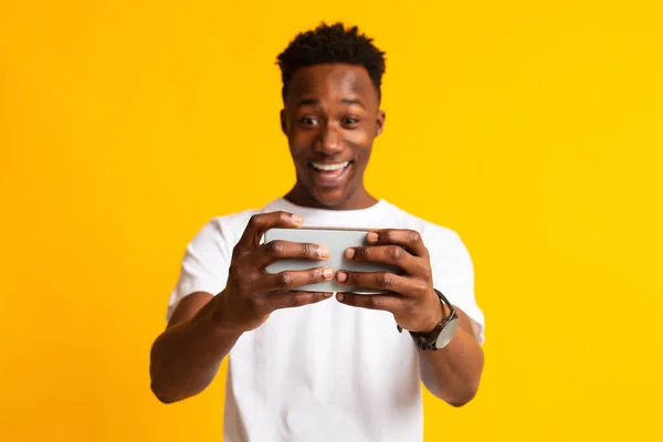 Portrait of excited young african man playing games — Stock Photo, Image