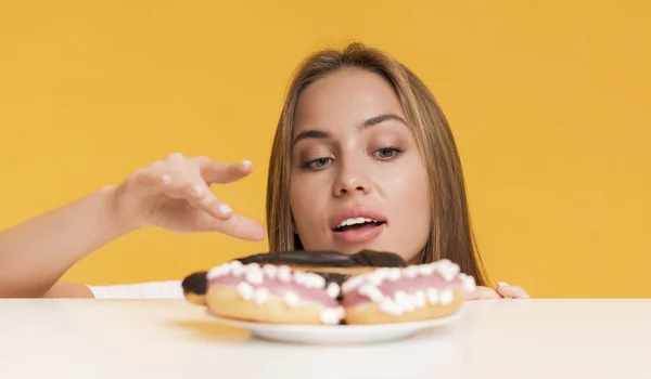 Hungry Girl Taking Sweets From Plate, Fancy About Unhealthy Junk Food — Zdjęcie stockowe