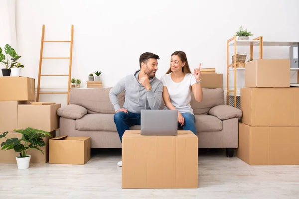 Happy couple thinking about designer project of new apartment — Stockfoto