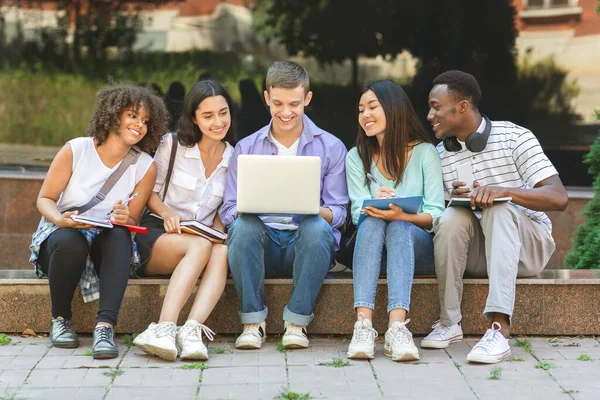 Group Of University Students Using Laptop Outdoors, Preparing For Classes Together — 스톡 사진