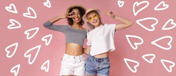 Two happy young girls in summer clothes and drawn hearts on pink background, panorama — ストック写真