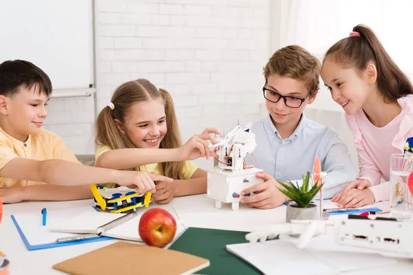 Early development concept. School children creating robots — Stok fotoğraf