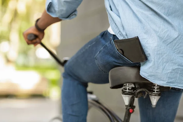 Wallet Falling Down From Pocket Of Unrecognizable Afro Guy On Bike — Zdjęcie stockowe