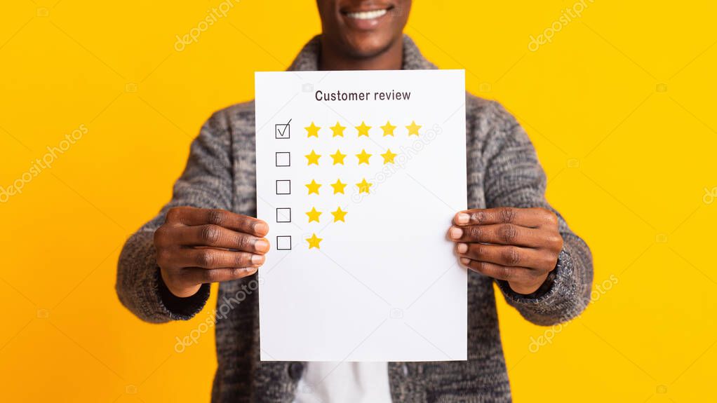 Unrecognizable blurred african man holding customer review