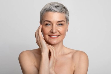 Nude Portrait Of Beautiful Mature Woman Over Light Background, Closeup