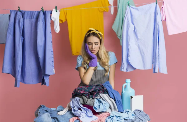 Sad housewife puts her hand to her cheek — Stok fotoğraf