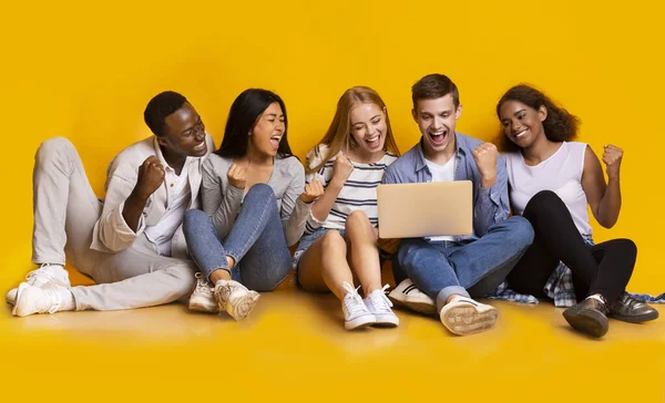 Group of classmates checking exam results online, using laptop — Stock Photo, Image