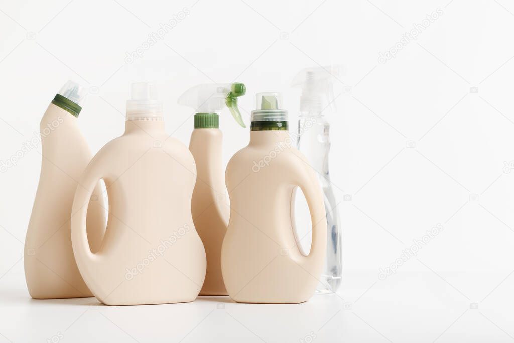 Detergent bottles and chemical cleaning supplies on white