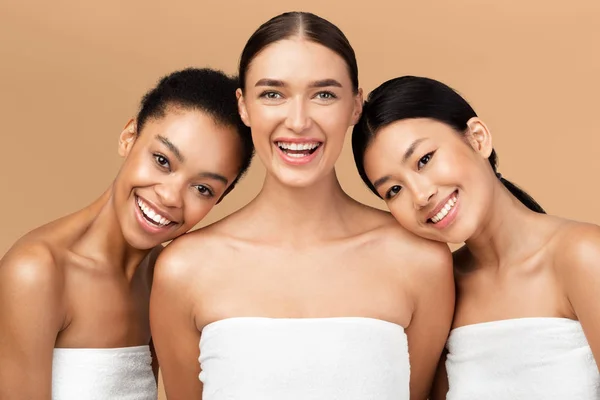 Three Ladies Wrapped In Bath Towels Posing On Beige Background — Stock Photo, Image