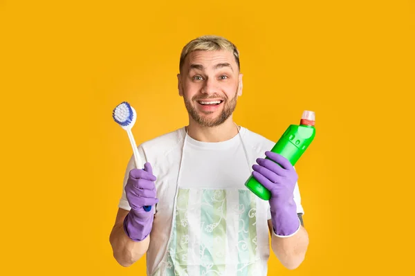 Mosolygós fickó tartja kefe és tisztító kellékek — Stock Fotó