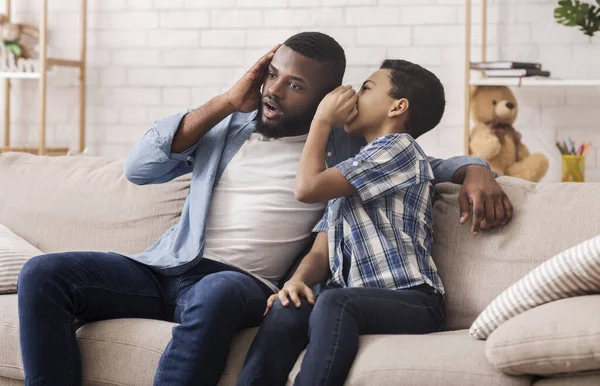 Black Son Sharing Secret With Dad, Whispering To His Ear — Stock Photo, Image
