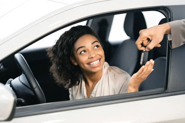 Dealer gibt Frau Schlüssel für Testfahrt im Autohaus — Stockfoto