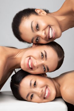 Three Multicultural Ladies Posing Over Gray Background, Beauty Portrait, Vertical