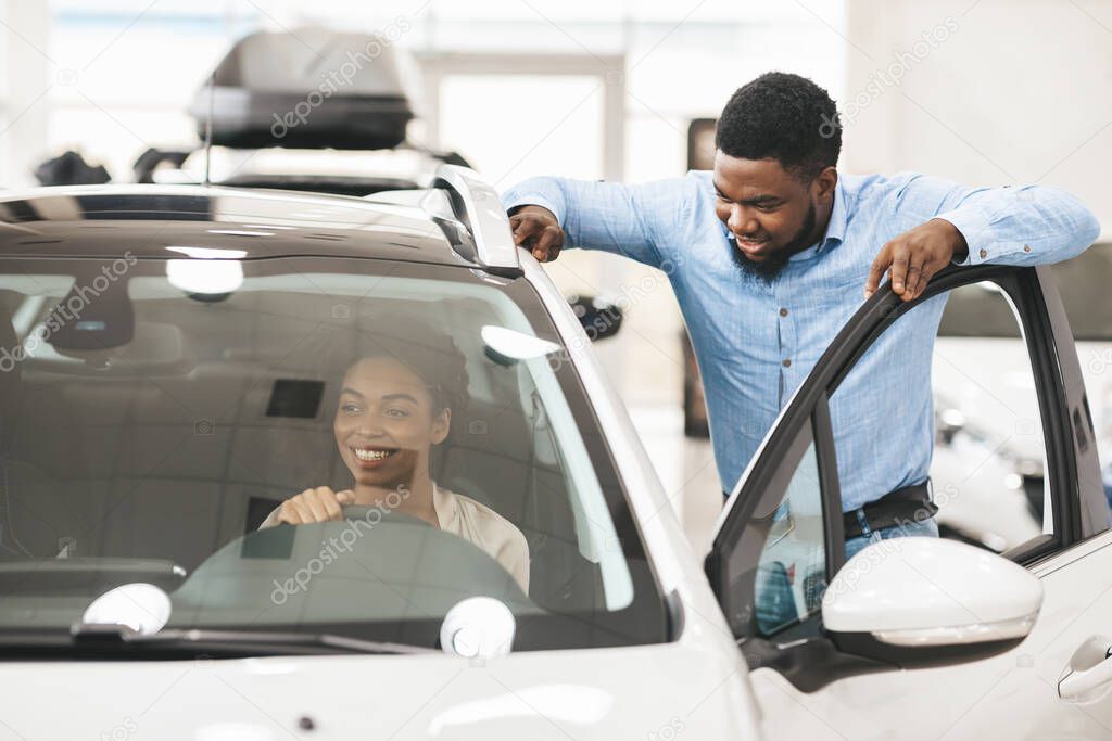 African Man Buying Car For His Wife In Dealership Store