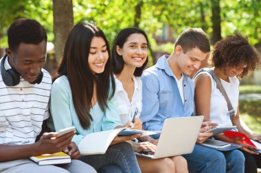 International students preparing for classes together in university courtyard