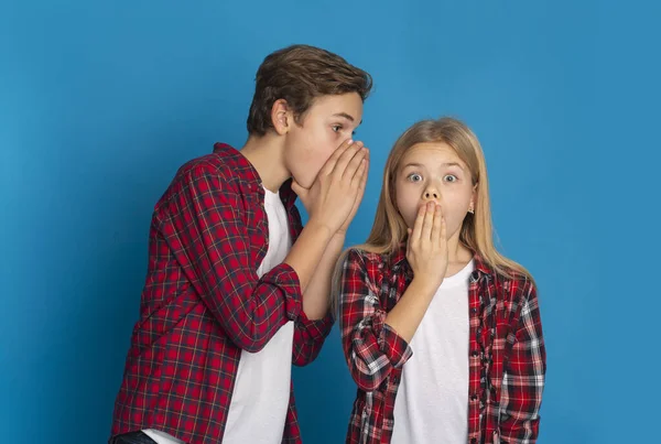 Brother Sharing Secrets With His Little Sister, Whispering Gossips To Her — Stok fotoğraf